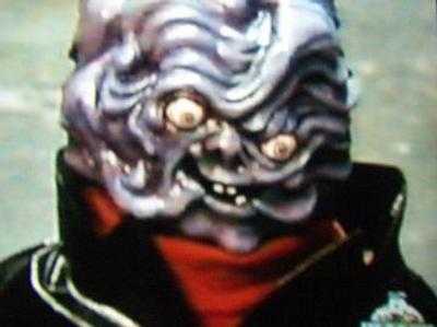 An image of Gooey Gus from the Ghostwriter TV show, a frightening purple monster with bulbous eyes and a head that looks like melted chewing gum.